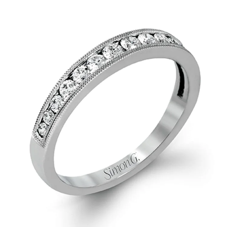 ladies rings simple delicate charm -This dramatic contemporary white gold ring is accentuated by .37 ctw round cut white diamonds and features .30 ctw glimmering side stones.