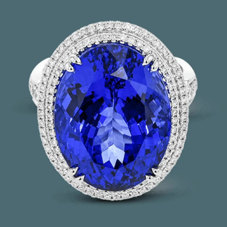 ladies rings vintage chic look -This right hand ring makes a statement with a stunning faceted Tanzanite center 20.44 ctw., held in place with double claw prongs, and has a double halo of white diamonds 1.05 cttw. The white gold setting has rose gold accents.