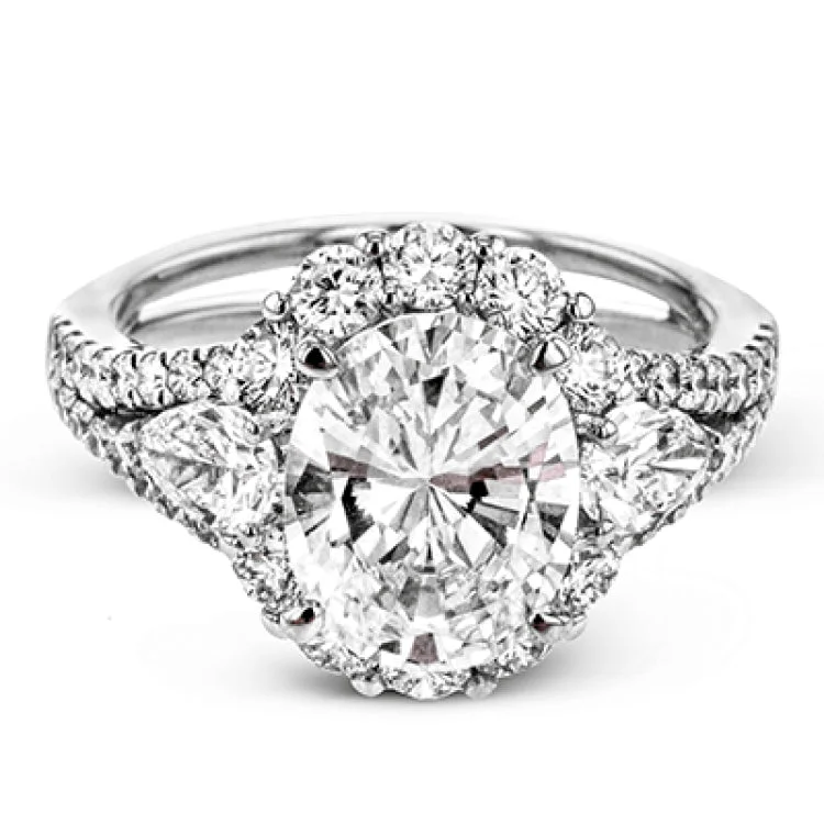 ladies rings promise ring design -This glamorous white gold ring features 1.01 ctw of round white diamonds and .62 ctw of pear shaped white diamonds as a dazzling backdrop for the center stone