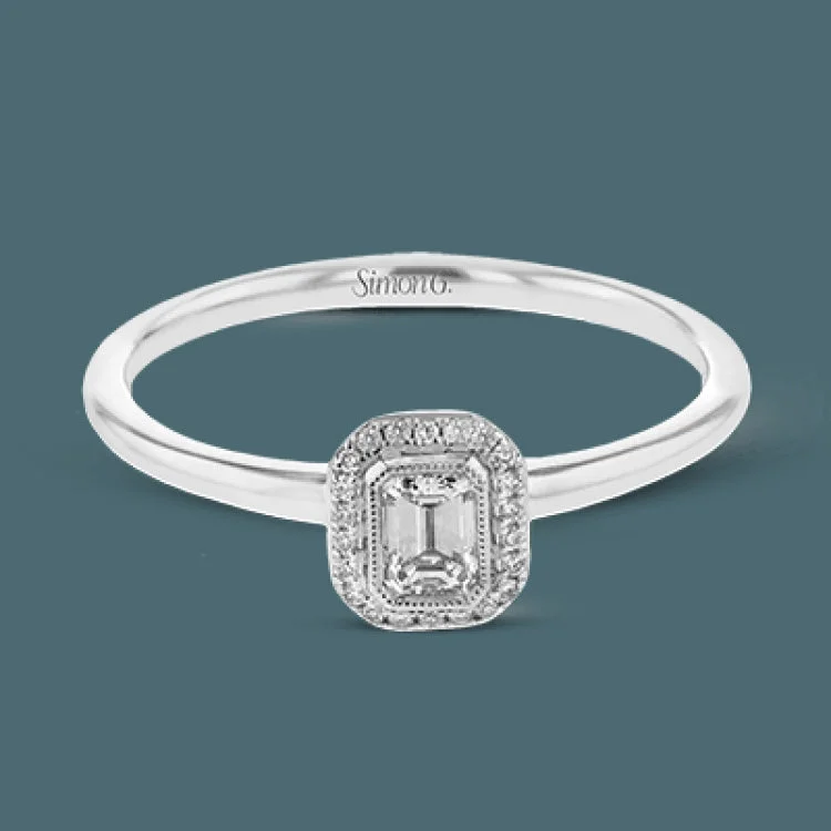 ladies rings for mother gift -This exquisite, minimalist yellow gold ring features a halo containing .04 ctw of round white diamonds encircling a .16 ctw emerald cut white diamond