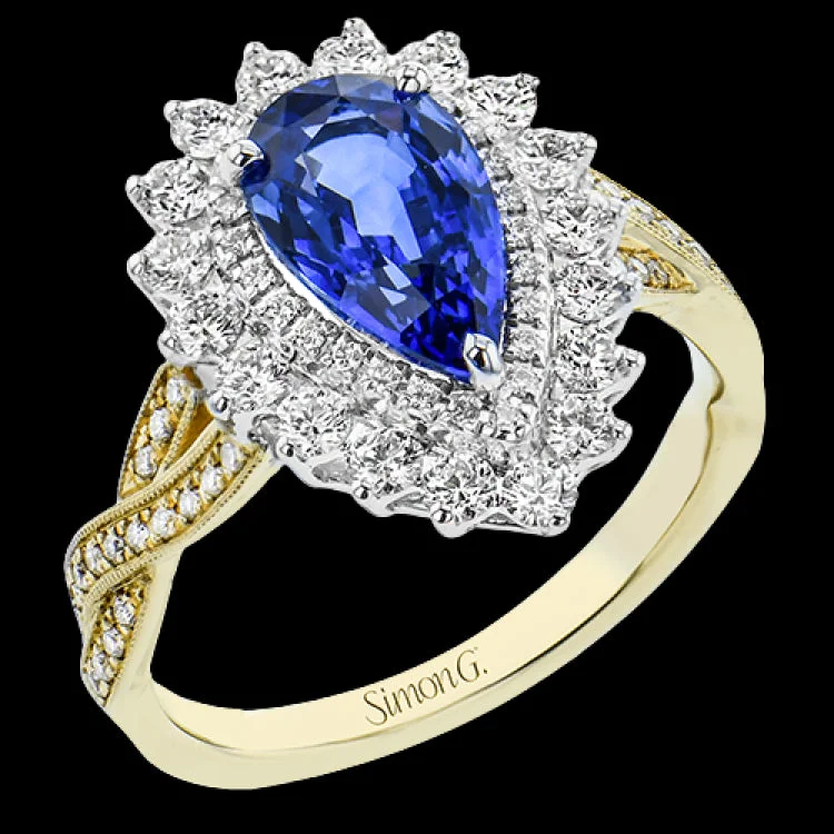 ladies rings for proposal gift -A unique color ring in 18K 2tone features a pear shaped sapphire center 2.56 ctw., surrounded by a double halo of white diamonds .76 ctw, and has a diamond accented yellow gold twist shank.