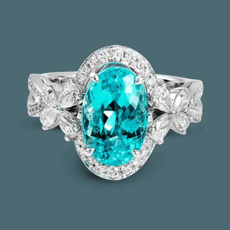 ladies rings for office elegance -This ring is truly extraordinary, centering around an incredibly bright 4.04 ctw paraiba tourmaline. This is surrounded by .31 ctw of round diamonds and .66 ctw of pear shaped diamonds set into nature inspired elements crafted in 18k white gold.