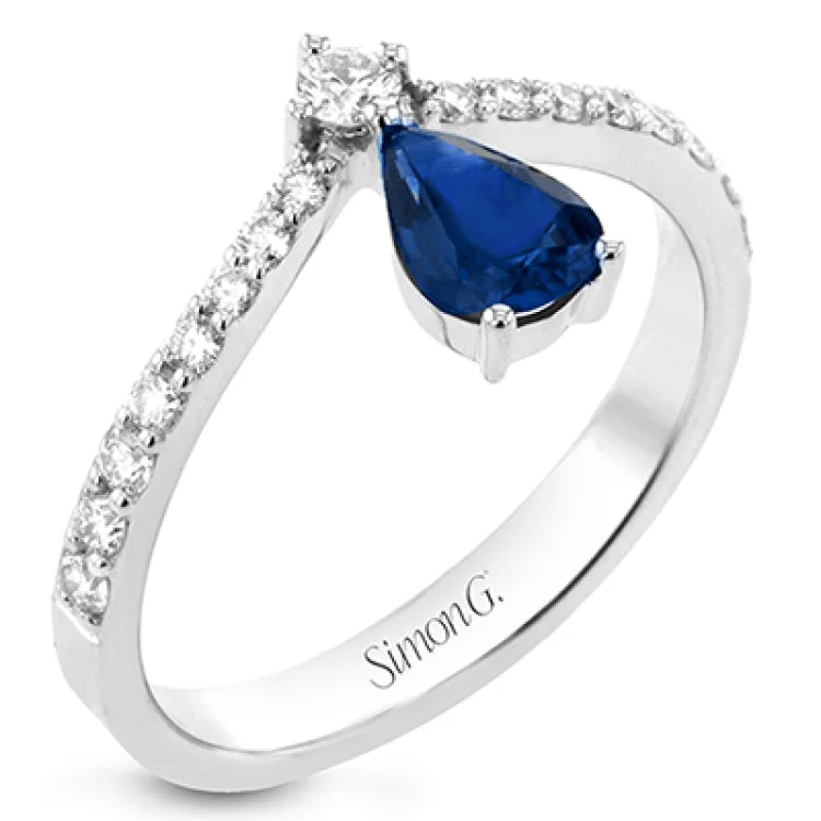 ladies rings for anniversary love -This fashionable 18k white gold ring features an inverted teardrop 0.74ct sapphire atop a diamond in the center of its attention-grabbing design.