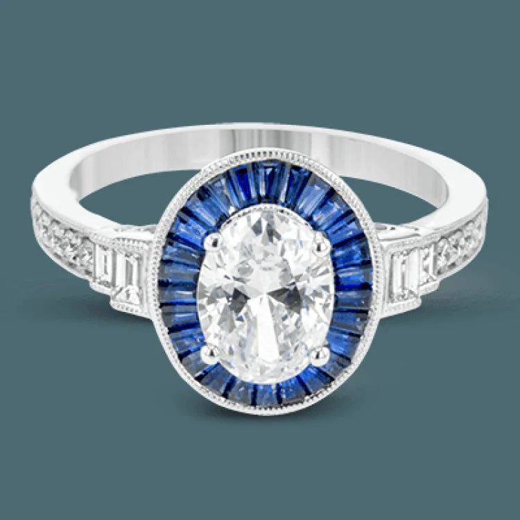 ladies rings floral pattern beauty -This remarkable ring features milgrain edging and .75 ctw of baguette shaped sapphires in its halo, flanked by .11 ctw of round white diamonds and .16 ctw of baguette shaped white diamonds.