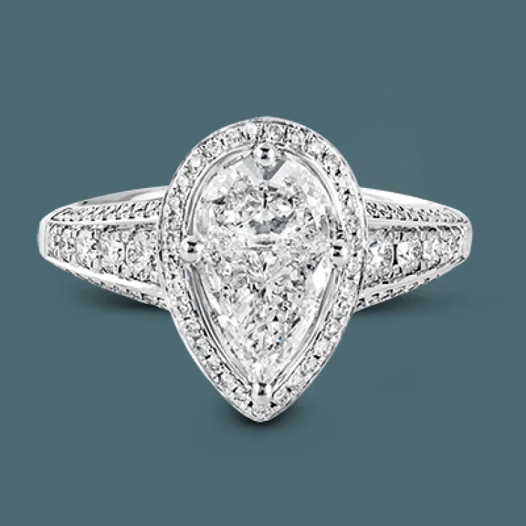 ladies rings with star detail -This remarkable 18k white gold ring contains a 1.28 ctw two-piece mosaic center which creates the look of a pear shaped diamond. This centerpiece is accented .48 ctw of white round brilliant diamonds.