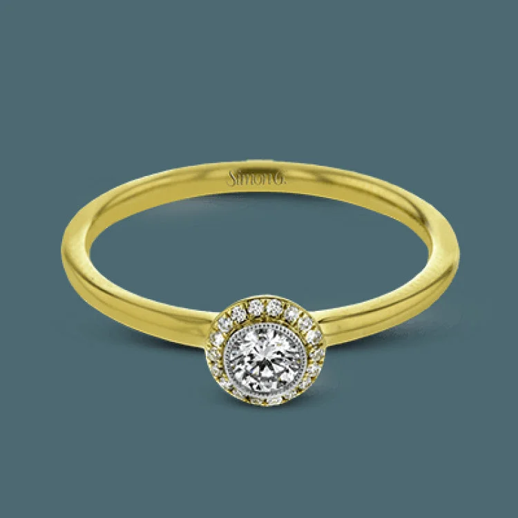 ladies rings for daily wear -This exquisite, minimalist yellow gold ring features a halo containing .04 ctw of round white diamonds encircling a .16 ctw round white diamond centerpiece