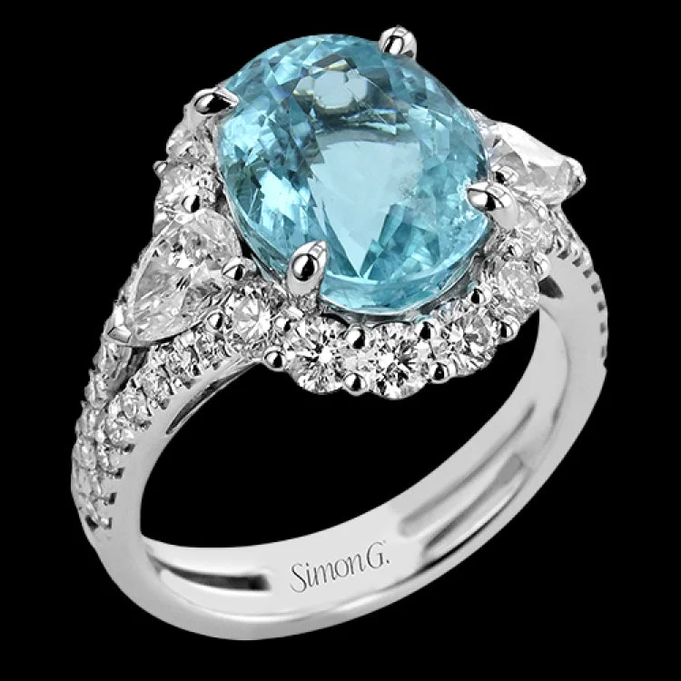 ladies rings dramatic bold style -This stunning  right hand ring features a 6.09 ctw sapphire center, surrounded by 1.06 ctw of round brilliant diamonds, and 2 pear shaped diamonds 0.60 cttw.