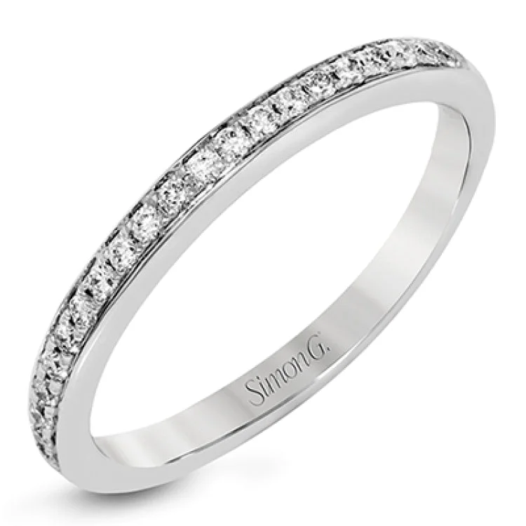 ladies rings eternity band style -This delightful ring is crafted from 18k white gold and features a .30 ct white diamond in the center of .50 ctw of smaller round white diamonds.