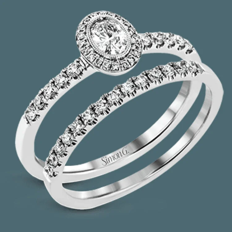 ladies rings luxury brand appeal -A .18 ct oval center diamond in a halo is the focus of this darling set of rings, while .37 ctw of pave set diamonds are the final perfecting touch.