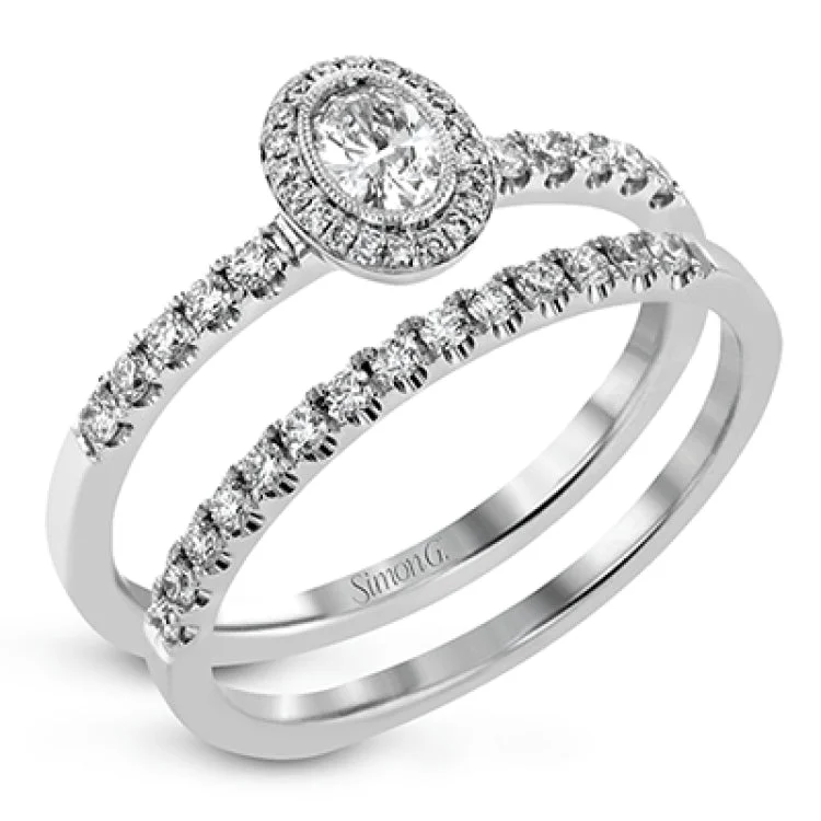 ladies rings platinum sleek shine -A .18 ct oval center diamond in a halo is the focus of this darling set of rings, while .37 ctw of pave set diamonds are the final perfecting touch.