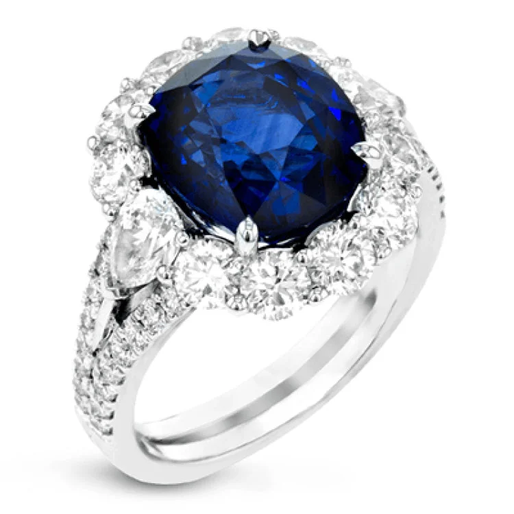 ladies rings custom personalized -This stunning  right hand ring features a 6.09 ctw sapphire center, surrounded by 1.06 ctw of round brilliant diamonds, and 2 pear shaped diamonds 0.60 cttw.