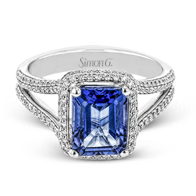 ladies rings with emerald green -This splendid white gold ring features a delicate split shank and halo, set with .46 ctw of round white diamonds, framing a lovely 2.71 ctw emerald cut tanzanite.