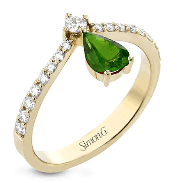 ladies rings with birthstone glow -This fashionable18k yellow ring features an inverted teardrop 0.48ct emerald atop a diamond in the center of its attention-grabbing design.