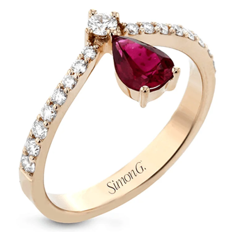 ladies rings sleek modern style -This fashionable 18k rose gold ring features an inverted teardrop 0.65ct ruby atop a diamond in the center of its attention-grabbing design.