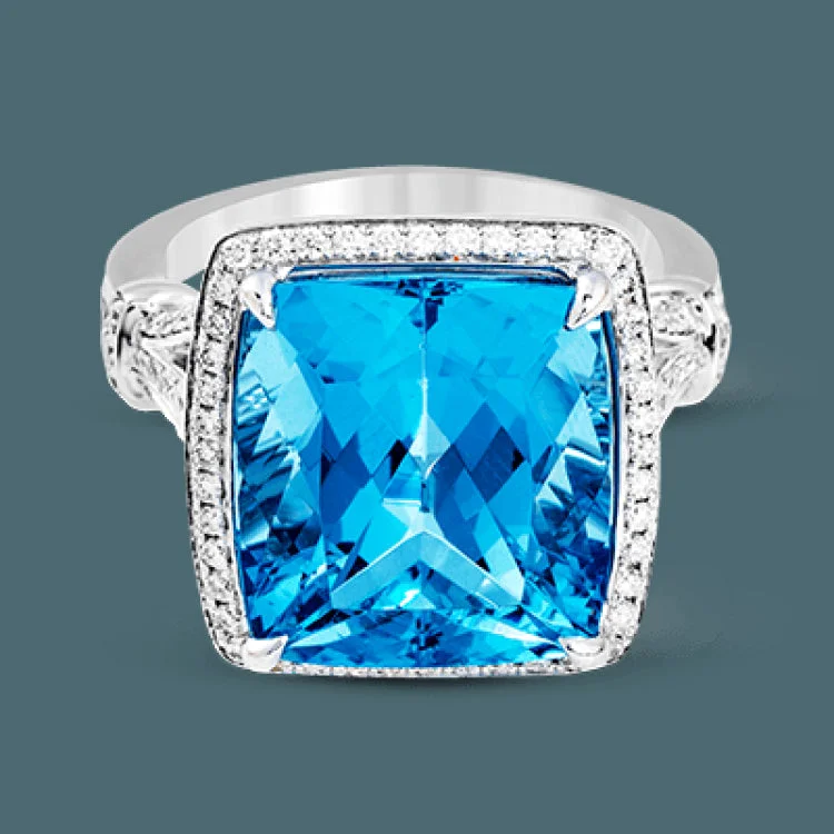 ladies rings classic timeless appeal -A bright blue 9.57 ct aquamarine is the central focus of this classic halo 18k white gold ring set with .68 ctw of white diamonds.