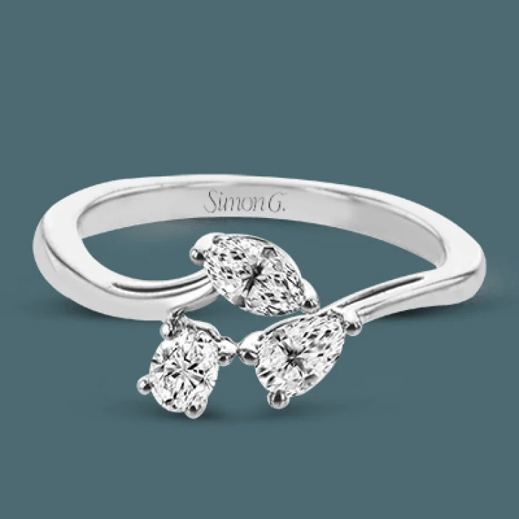 ladies rings dramatic bold style -Combining old and new, this fresh take on a three stone ring contains a .15 ct pear shaped diamond, a .16 ct marquise cut diamond and a .15 oval cut diamond.