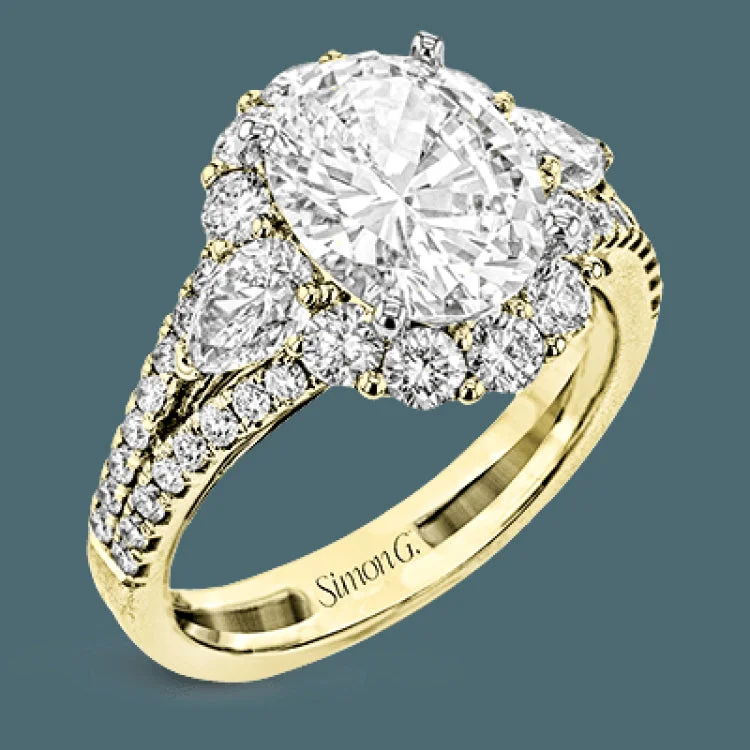 ladies rings two tone metal -This glamorous white gold ring features 1.01 ctw of round white diamonds and .62 ctw of pear shaped white diamonds as a dazzling backdrop for the center stone